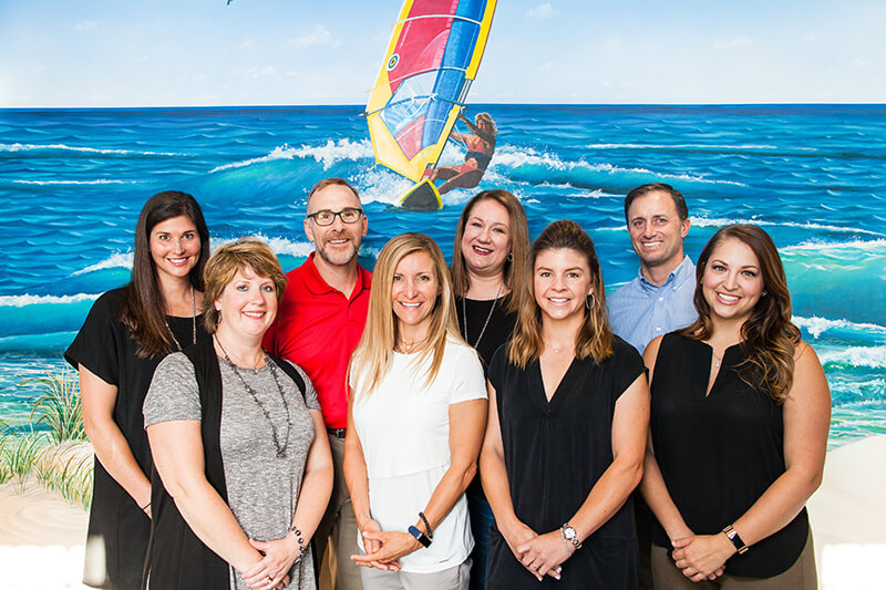 Team picture by the surf - Pediatric Dentistry and Orthodontics in Corpus Christi, TX